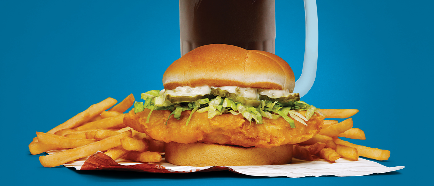 Cod Sandwich, Fries, and mug of A&W Root Beer on a dark blue background